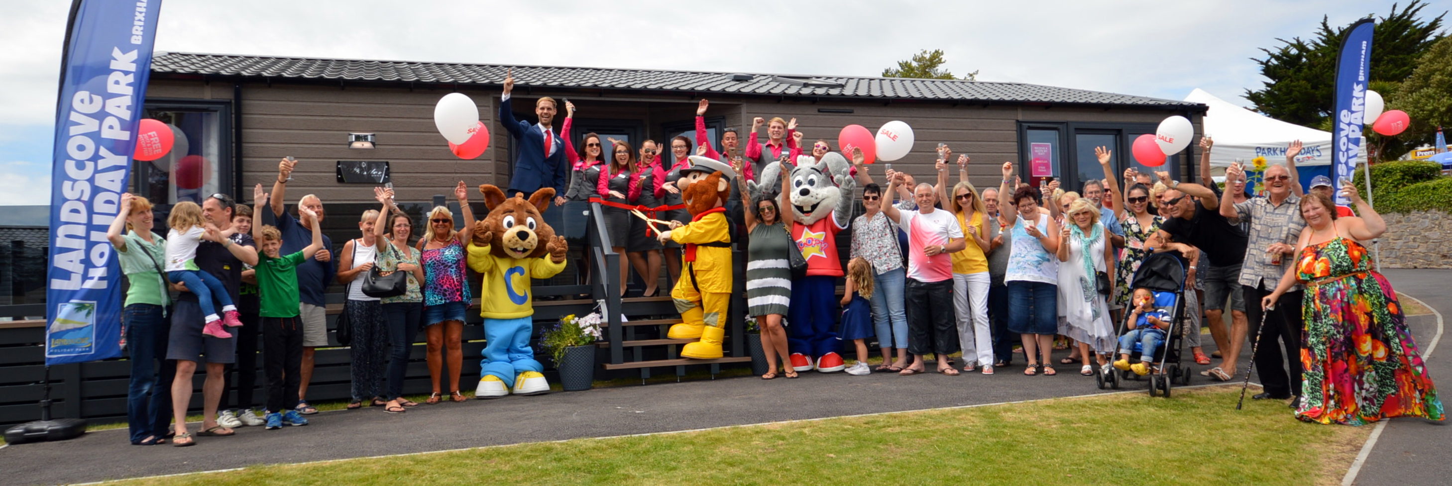 Making waves at Brixham: guests, park staff and the RNLI celebrate at the launch of the new lodge development