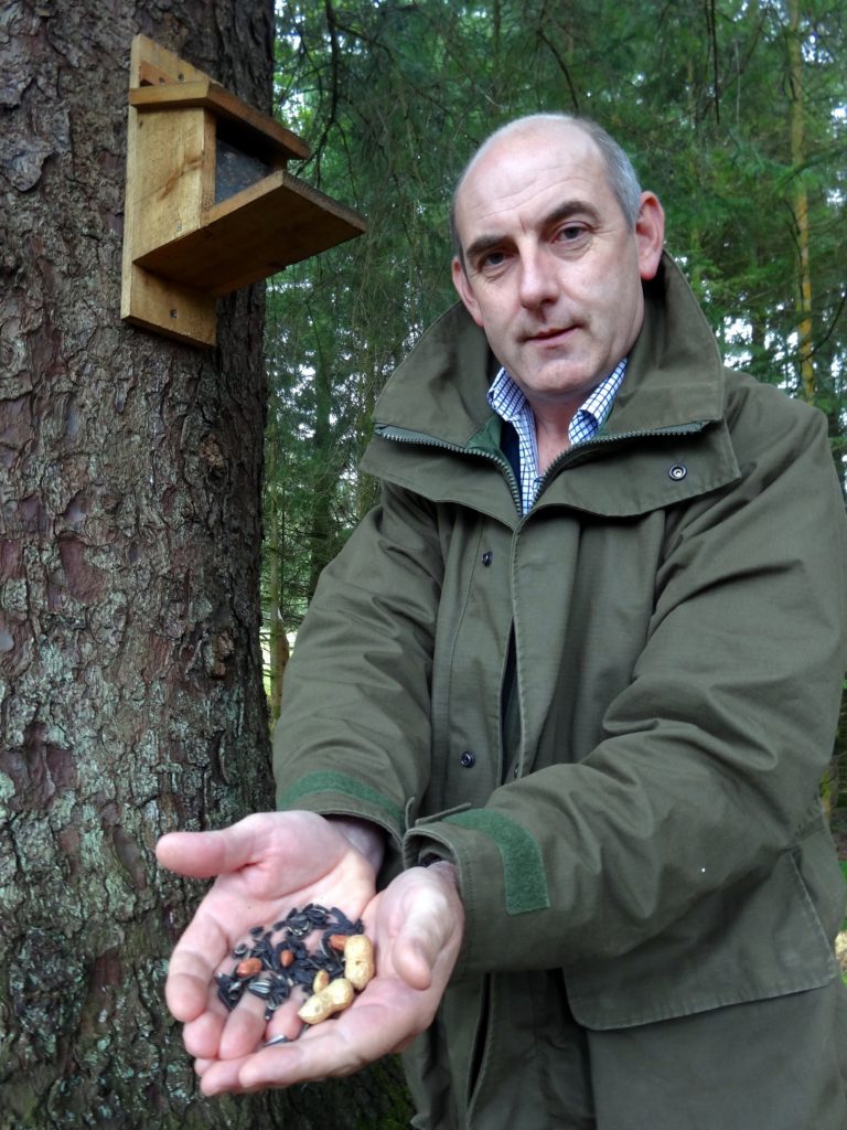 Henry Wild tops up the park's feeding stations with a special seed mix with aniseed, loved by red squirrels</em><figcaption id=