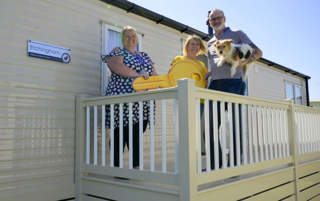 Stephen, with friend Janet and terrier Tiny, are congratulated by Harts Holiday Park general manager Donna Hough