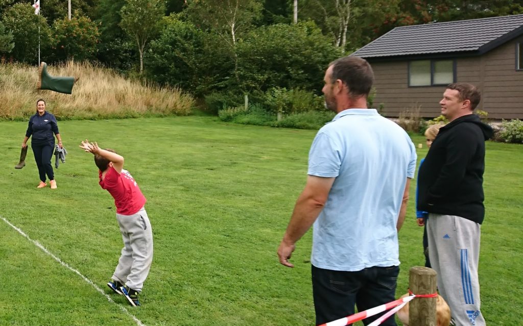 Give it some welly: youngsters and grown-ups did their best to claim the record for the day's longest throw</em srcset=