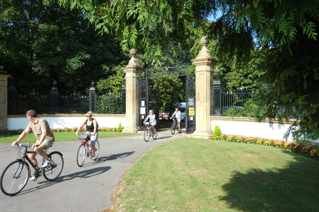 The imposing gates to South Lytchett Manor, and the starting point for rural rides in away-from-it-all Dorset</em srcset=