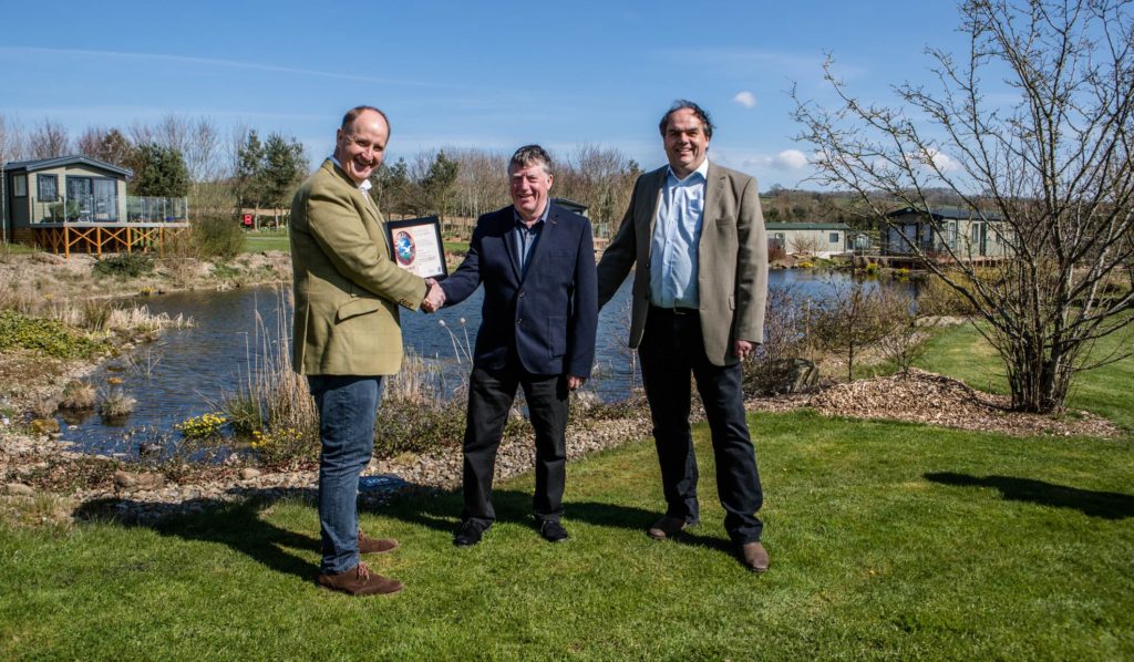 Kevin Hollinrake MP congratulates long-serving park manager Trevor Jones and business owner Mark Goodson 